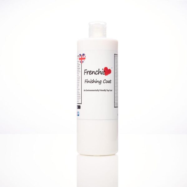 Frenchic Finishing Coat bottle on a rustic wooden table with exposed brick wall background
