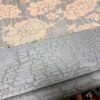 Close-up of a weathered, cracked paint finish on a decorative wooden surface, showcasing vintage charm and aged character.