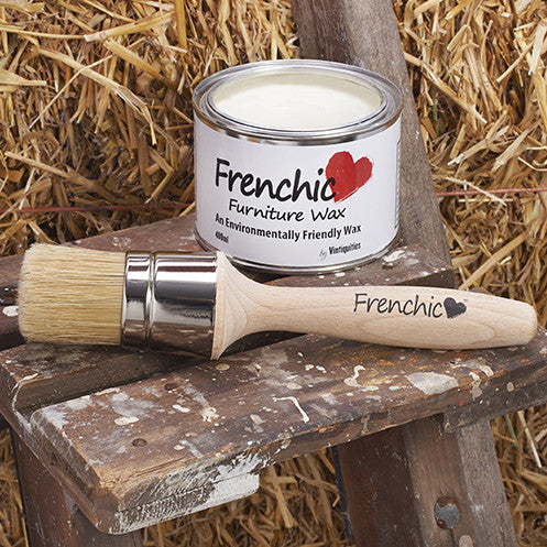 Frenchic Furniture Wax tin and Frenchic Wax Brush on rustic wooden stool with straw background