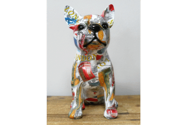 Decorative dog sculpture with colourful, abstract patterns and a glossy finish, displayed on a wooden surface.