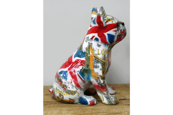 Decorative ceramic bulldog figurine painted with the Union Jack flag design, sitting on a wooden surface.