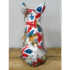 Decorative ceramic cat figurine painted with a colourful collage of British-themed images and patterns.