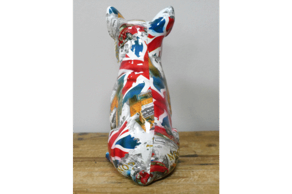 Decorative ceramic cat figurine painted with a colourful collage of British-themed images and patterns.