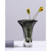 Elegant green glass vase with yellow and green flowers, ideal for home decorating and floral arrangements.
