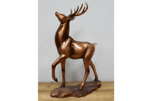 Bronze stag ornament with detailed antlers on a wooden base, ideal for home decorating and festive displays.