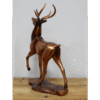 Decorative bronze stag ornament with detailed antlers, standing on a wooden base, ideal for home decor or as a gift.