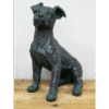 Bronze dog sculpture sitting on a wooden surface, detailed and artistic.