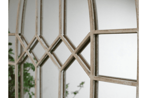 Close-up of a rustic wooden mirror frame with geometric diamond patterns, suitable for home decorating projects.