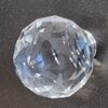 Clear glass globe cabinet knob with faceted design, ideal for home decor and furniture upgrades.