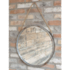 Industrial round mirror with metal frame and rope hanging on a brick wall, ideal for home decorating.