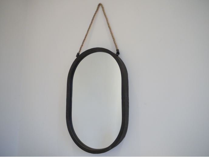 Black oval mirror with a rope hanger, suitable for modern home decor, displayed on a plain wall.