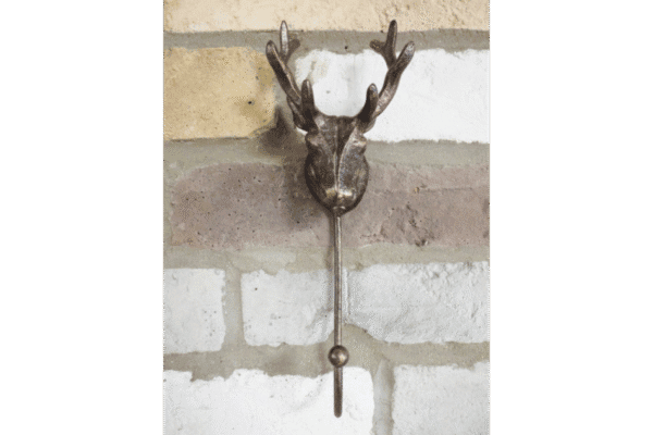 Decorative single stag hook with antler design mounted on a brick wall for home decor.
