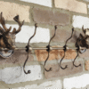 Decorative stag head coat hook set of 4 with antler design, mounted on a brick wall, ideal for rustic home decor and entryway organisation.