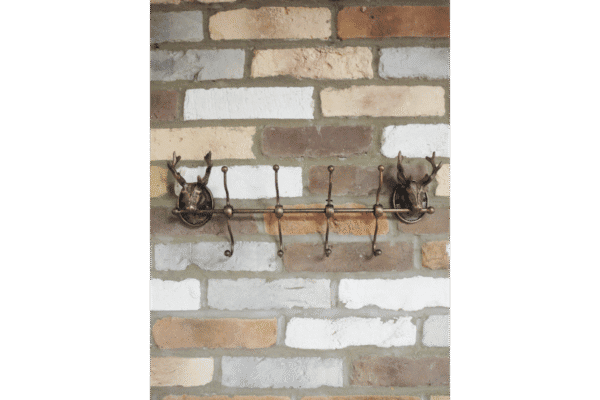 Decorative stag coat hook set of 4 with metal antlers and wooden base, mounted on a brick wall, ideal for rustic home decor.
