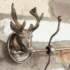 Decorative stag head coat hook set of 4 mounted on a brick wall, ideal for home decor and functional storage.