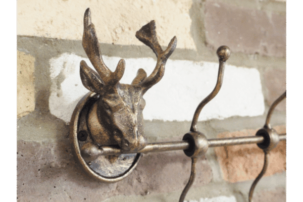 Decorative stag head coat hook set of 4 mounted on a brick wall, ideal for home decor and functional storage.