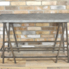 Industrial console table with metal frame and wire shelf, ideal for home decor and storage solutions.