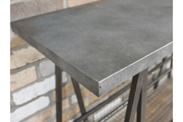 Close-up of an industrial-style console table with a concrete top and metal legs, suitable for modern home decor.