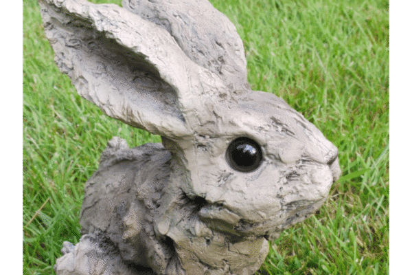 Wood effect bunny sculpture with realistic features on a grassy background, ideal for garden decor or home decoration.