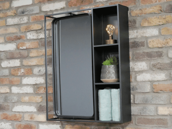 Industrial wall unit with mirror and shelving for home decor, featuring a light bulb, plant, and towels, mounted on a brick wall.