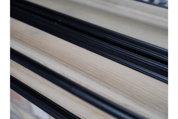 Close-up of black and natural wood-effect shelf edges for home decor and storage solutions.