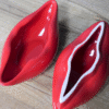 Red lips-shaped trinket box with glossy finish, perfect for decorative storage or gifting.