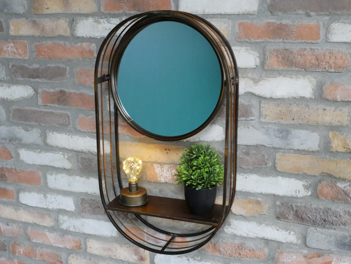 Industrial wall shelf unit with mirror, featuring a round mirror, a small potted plant, and a decorative light bulb, mounted on a brick wall.