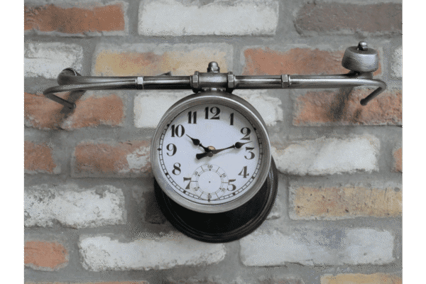 Handlebar bike clock mounted on a brick wall, combining vintage bicycle parts with functional timekeeping.