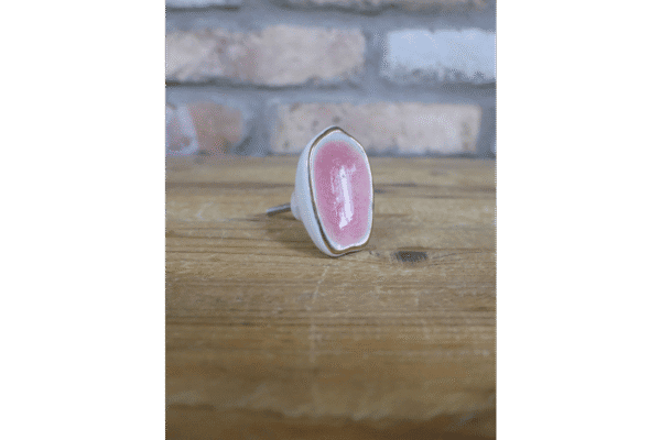 Ceramic pink cabinet knob with a glossy finish, perfect for home decorating projects.