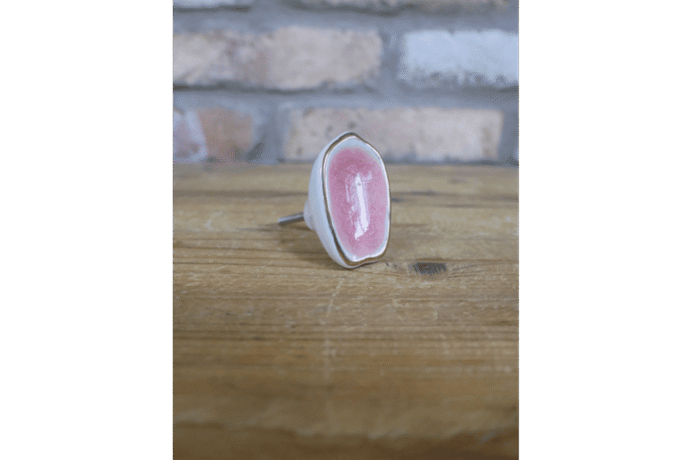 Ceramic pink cabinet knob with a glossy finish, perfect for home decorating projects.