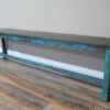 Blue distressed wooden bench with rustic finish, ideal for home decor or outdoor seating.