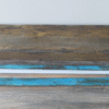Close-up of a blue distressed wooden bench with weathered paint and rustic finish.