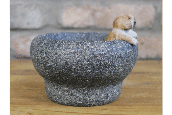 Small dog figurine in a textured stone-like trough, ideal for pet decor or small plant displays.
