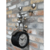Unique wall clock designed as a motorbike with side facing view, featuring metallic details and a brick wall background.