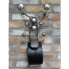Unique wall-mounted clock designed to resemble a motorbike with a brick wall background.