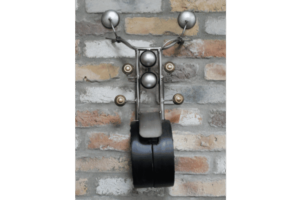 Unique wall-mounted clock designed to resemble a motorbike with a brick wall background.