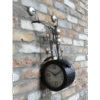 Unique motorcycle-themed wall clock with handlebars and mirrors, mounted on a brick wall, blending vintage and industrial decor styles.