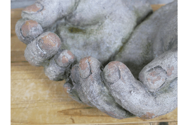 Close-up of weathered, textured hands ornament with detailed fingers and nails, showcasing aged, rustic appearance for home decorating.