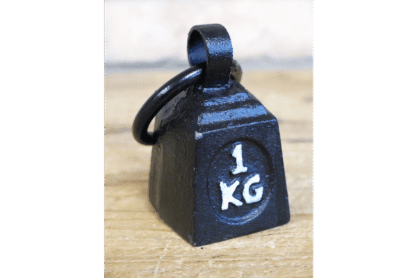 Black 1kg weight with a metal ring on top, placed on a wooden surface, used for weightlifting or exercise.