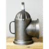 Vintage metal lantern with a handle and a large conical opening, placed on a wooden surface.
