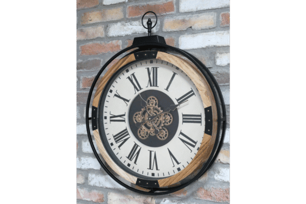 Industrial-style wall clock with visible gears and Roman numerals, mounted on a brick wall.