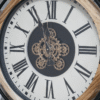 Cog clock with moving cogs and roman numeral lettering wood and black metal surround.