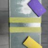 Stringers DIY sanding blocks in purple and yellow on a sanding board for home decorating projects.