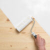 BIN shellac based adhesion primer being applied over knotted wood.
