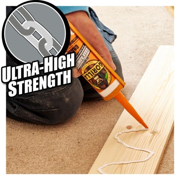 Applying Gorilla Heavy-Duty Grab Adhesive on wood for strong bonding in DIY home decorating projects.