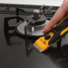 Olfa Pro Glass Scraper GSR-2 with ergonomic handle and safety cover in use on hob.