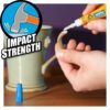 Person applying Gorilla Super Glue to fix a ceramic mug handle, showcasing strong impact strength and quick bonding.