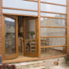 Exterior view of Stringers Home Decorating Centre showcasing wooden framed glass doors and windows.