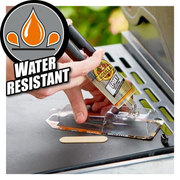 Applying Gorilla Epoxy Glue to a plastic surface with a precision syringe for strong, water-resistant bonding.