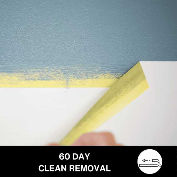 Applying Frogtape Delicate Surface painter's tape to a wall for clean paint edges during home decorating.